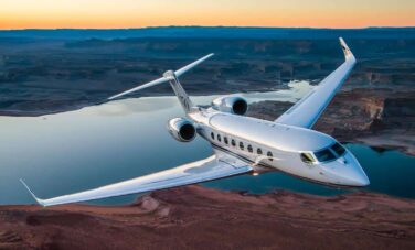 BBJ en vol avec couché de soleil au dessus de la mer et des côtes