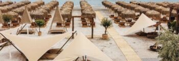 Une plage à Mamaia, des parasols beiges et l'océan.